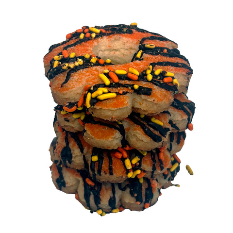 Stack of Halloween-themed cookies with orange, black, and yellow sprinkles on a white background