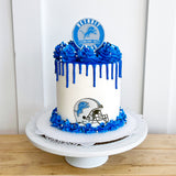Cake with blue and white design featuring Detroit Lions logo on a white background