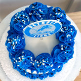 Cake with blue frosting flowers and Detroit Lions logo