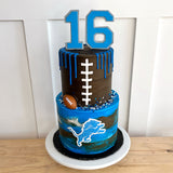 Cake with blue and brown design, number 16, football, and sports team logo on a white background.