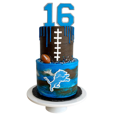 Cake with number 16, football design, and blue and brown colors on a white background