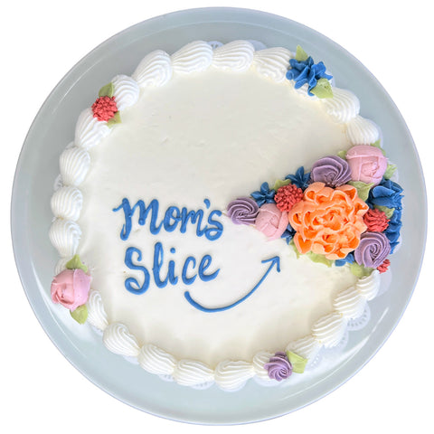 Decorative cake with colorful flowers and 'Mom's Slice' text on a white background