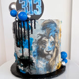Cake with a lion design and blue accents on a white background