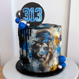 Cake with lion design and number 313 on top, surrounded by balloons.