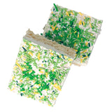 Rice Krispies Treats with white chocolate and green and yellow sprinkles on a white background